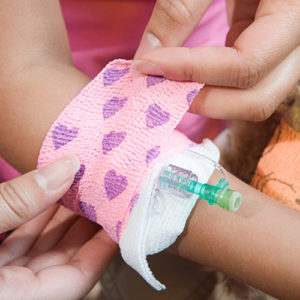 school nurse helping little girl