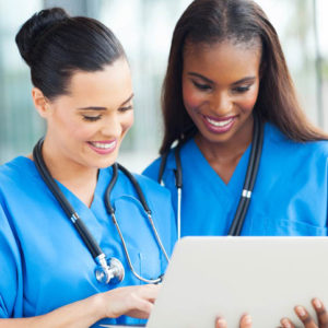 smiling nurses performing everyday nursing tasks