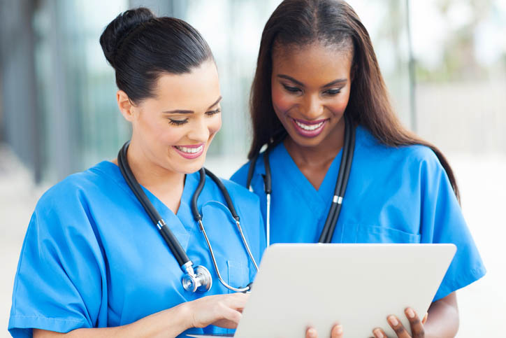 smiling nurses performing everyday nursing tasks