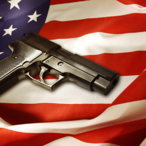 Handgun lying on American flag.