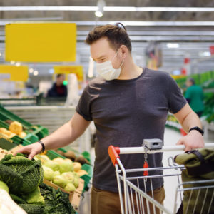 Man wears face mask in grocery store.