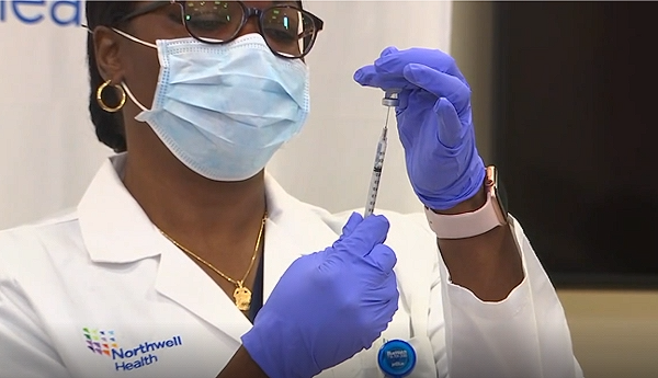 Dr. Michelle Chester administered the first FDA approved Covid vaccination to nurse Sandra Lindsay on December 14.