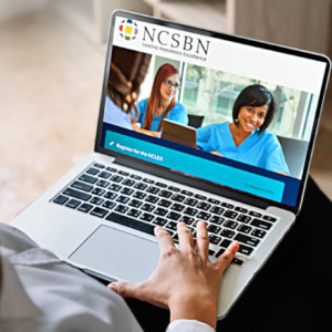 Woman looks at NCLEX website on a laptop.