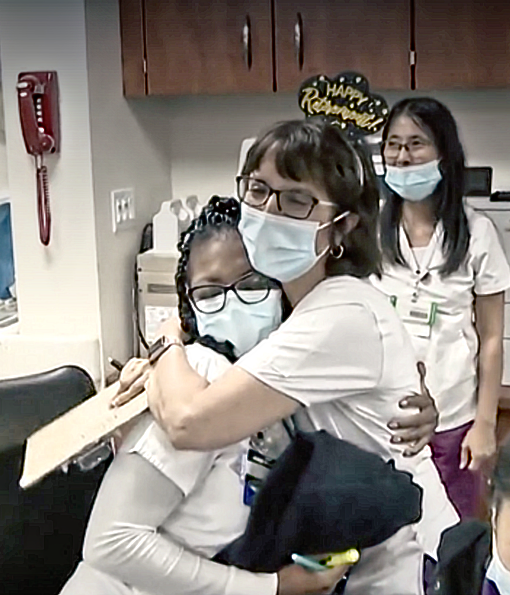 Sylvana Vega, RN hugs a co-worker as she departs to retire from nursing.