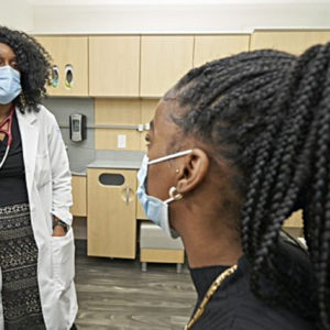 Nurse with patient at VA facility.