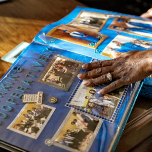 Rafiah Maxie with scrapbook belonging to Jamal Clay, her late son.
