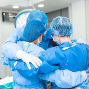 Nurses wearing PPE in preshift huddle.