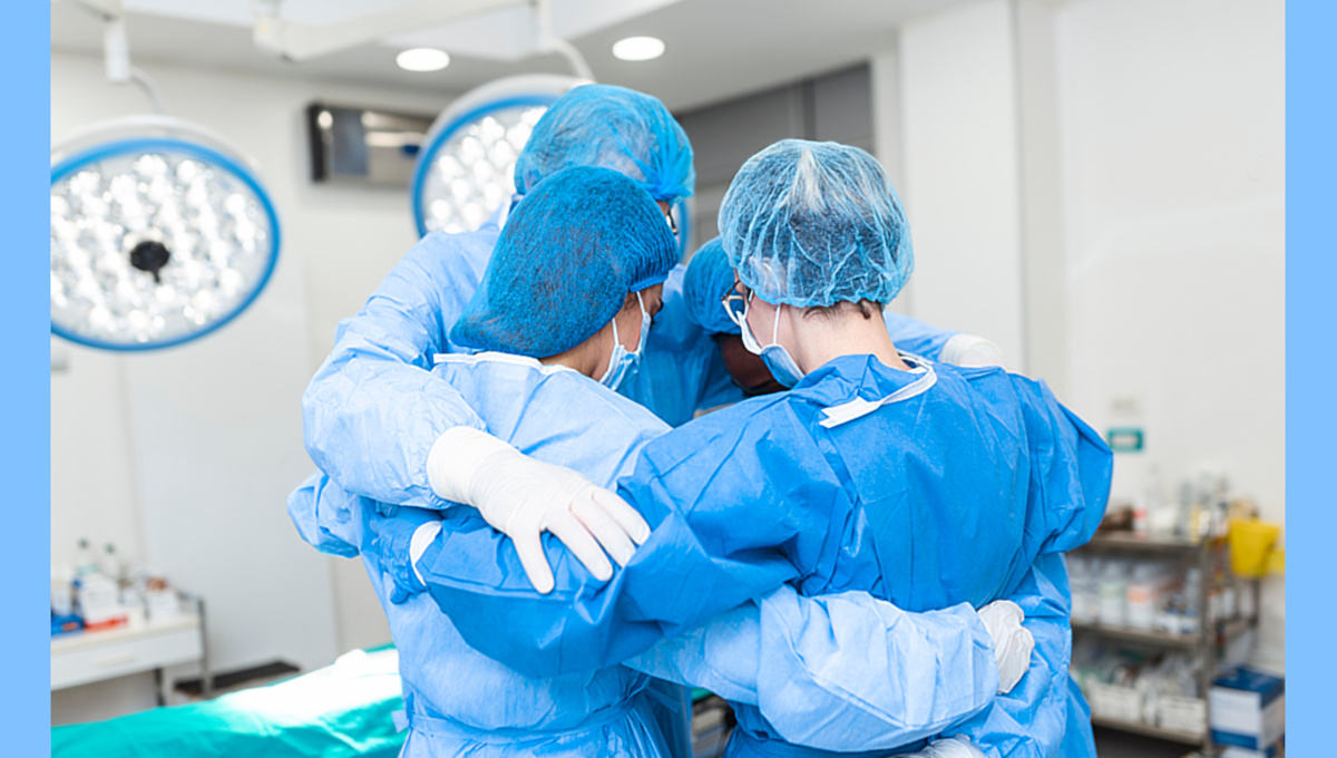 Nurses wearing PPE in preshift huddle.
