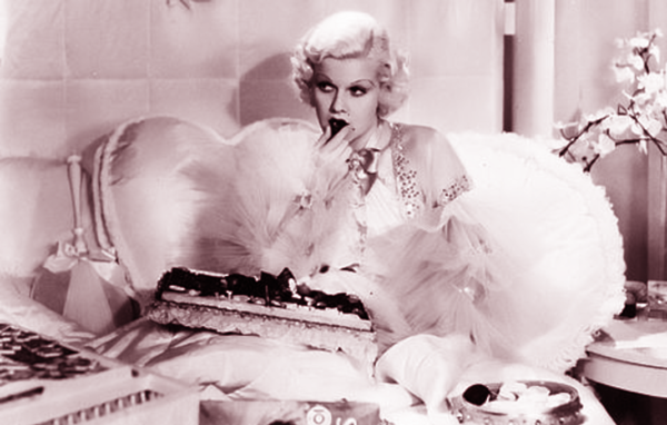 Jean Harlow in bed eating chocolates. If only self-care was this easy!