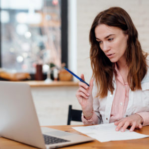 Online study groups: Woman studying on laptop.