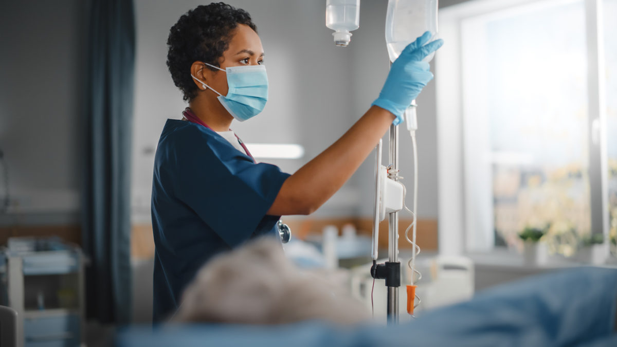 Black nurse at work on hospital ward.