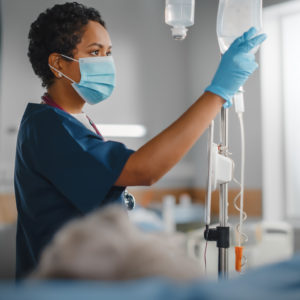 Black nurse at work on hospital ward.