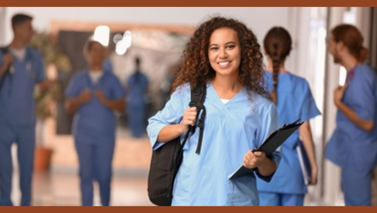 Nursing student in hospital corridor.