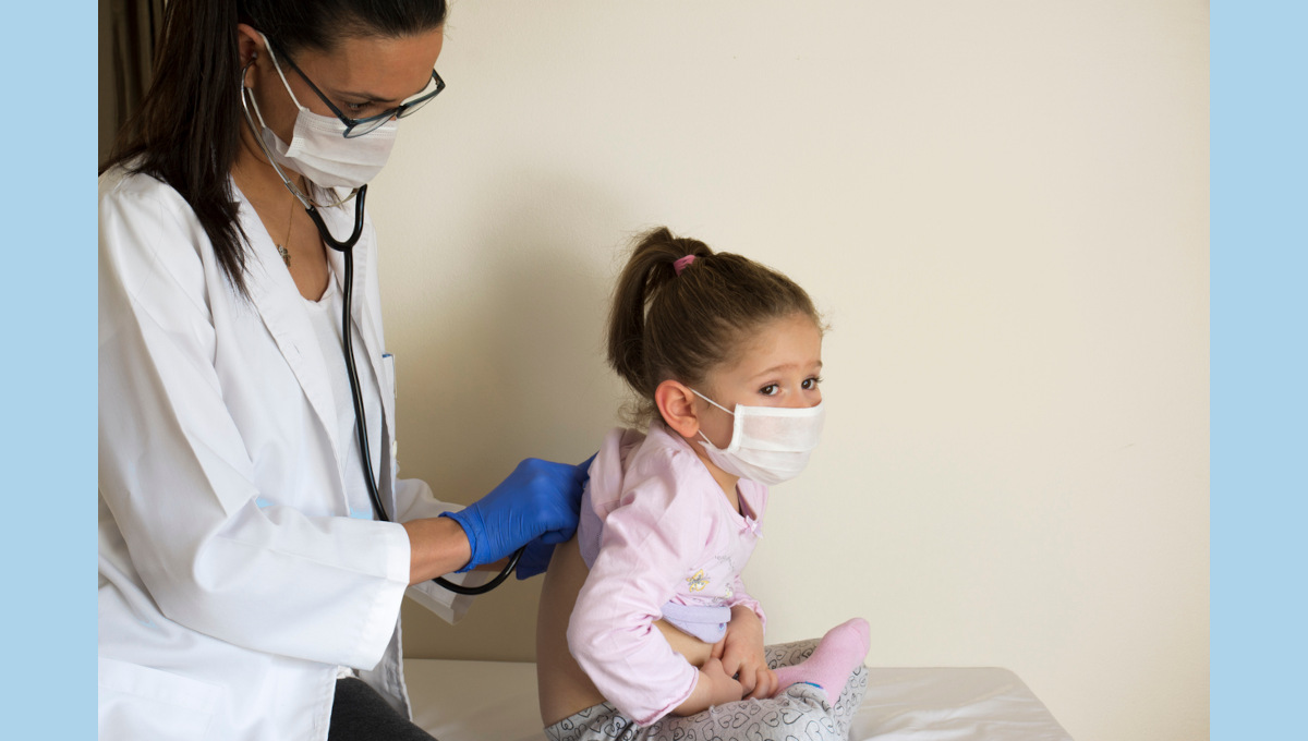 An FNP (family nurse practitioner) listens to a child's heart.