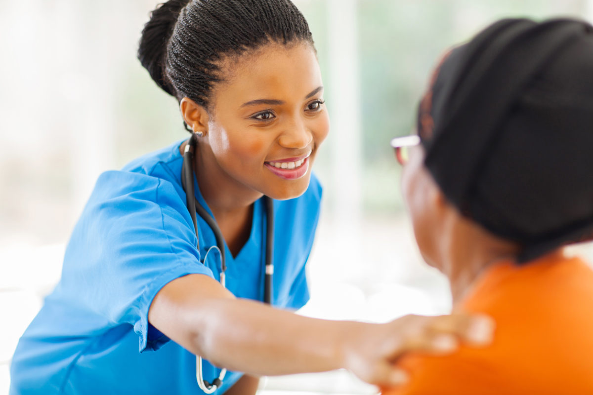 Black NP gives senior patient a check-up..