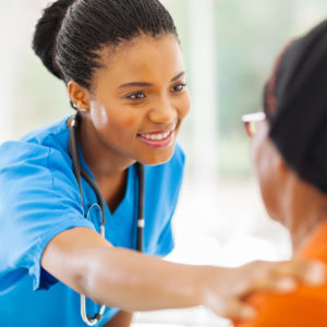 Black NP gives senior patient a check-up..