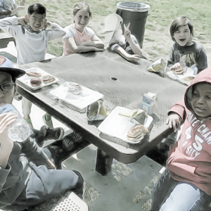 Grade school kids eating lunch.