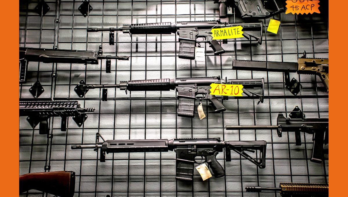AR rifles and other firearms on display in a shop./