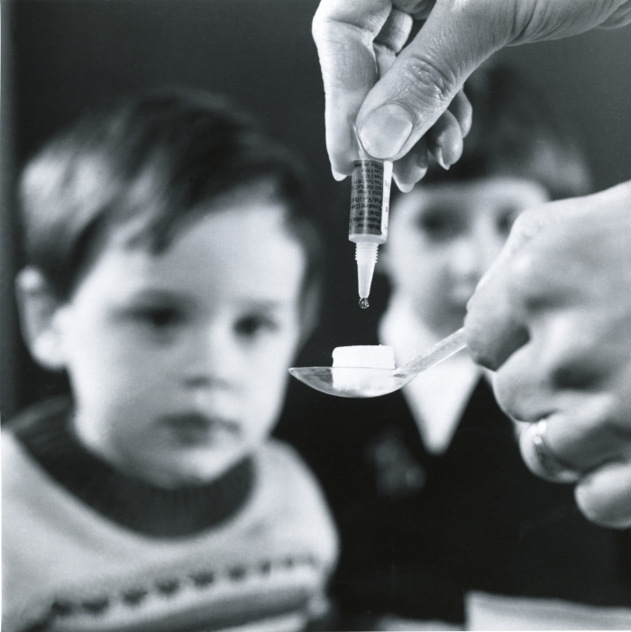 Polio vaccine. Child receiving the Sabin formula.