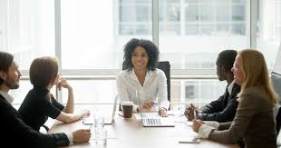 a diverse board of trustees sitting at a conference table