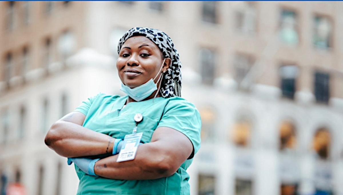 Healthy Black nurse in scrubs.