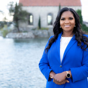 infusion nurse Danielle Jenkins standing outside in a blue blazer and white shirt