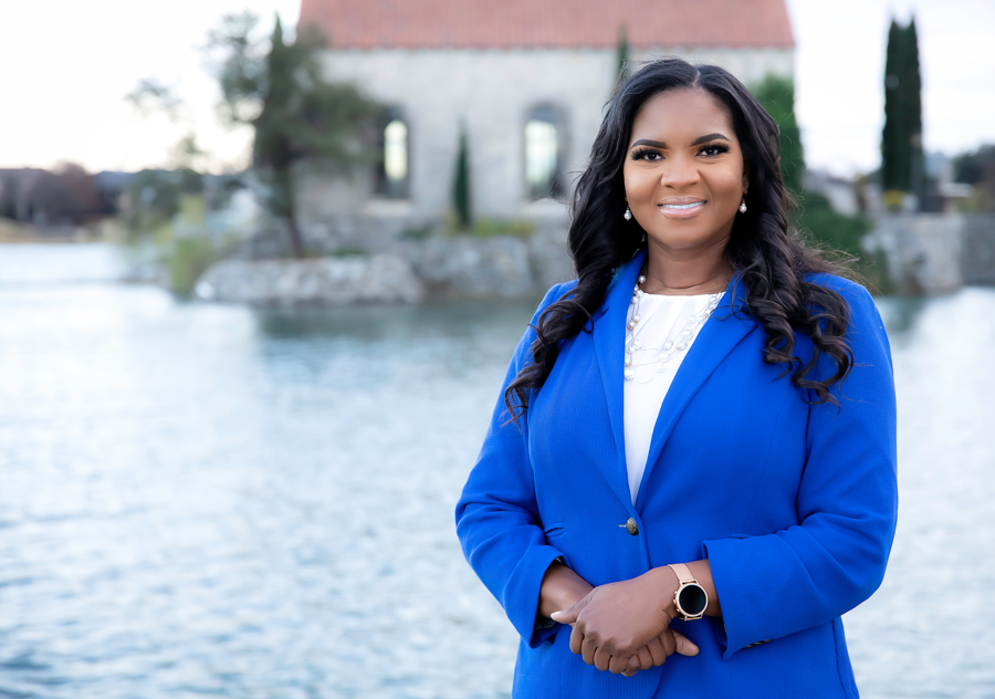 infusion nurse Danielle Jenkins standing outside in a blue blazer and white shirt