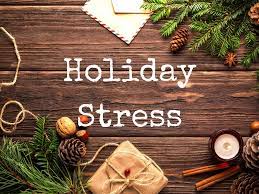 image of the words holiday stress on a background of a wooden tale and pine boughs