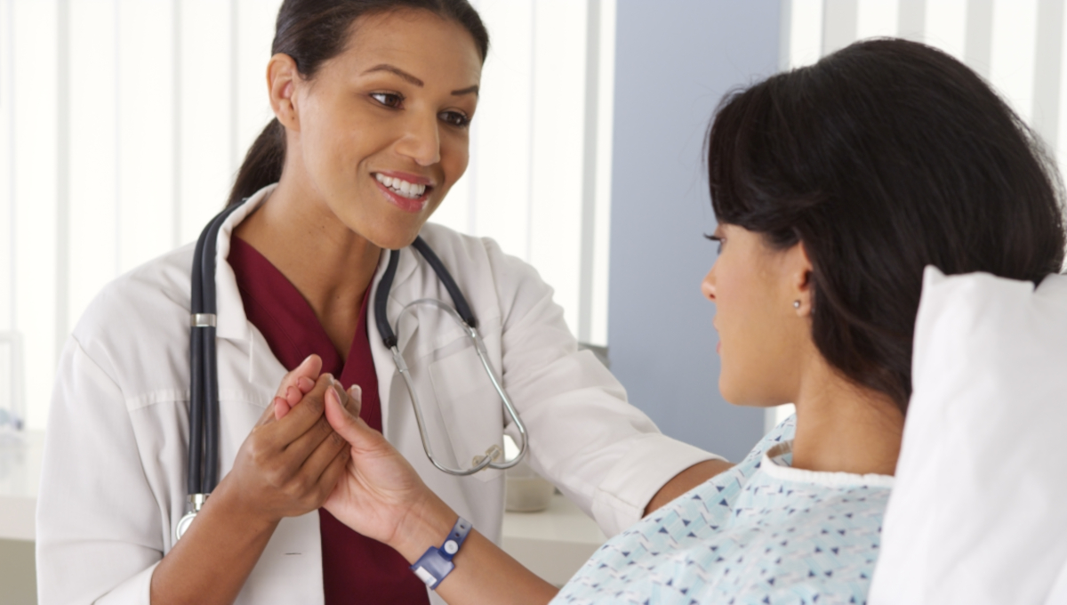 Latinx Hispanic FRNP (Family Nurse Practitioner) with patient.
