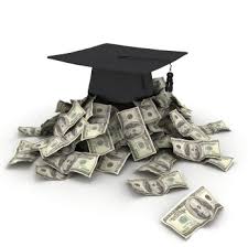 a black graduation cap sitting on top of a pile of money