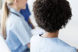 the backs of heads of two nurses