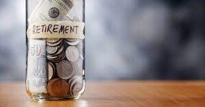 jar of coins with a paper label saying retirement