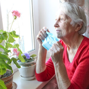 elderly woman looking out window
