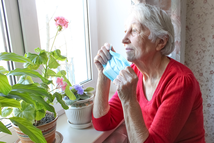 elderly woman looking out window