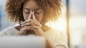 a woman holding her head down with two fingers against her forehead from holiday stress